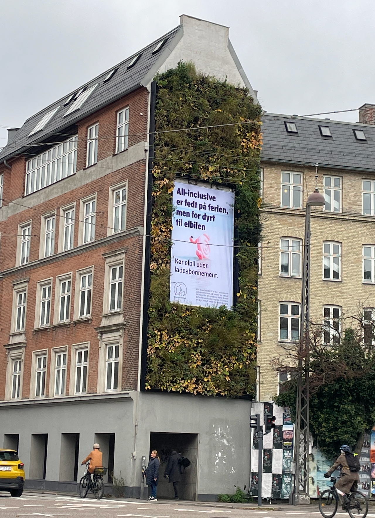EV charging billboard on green wall
